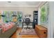 Cozy living room area featuring large windows and a dedicated workspace at 4649 Dahlia Dr, Pine Lake, GA 30072