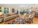 Inviting living room connected to dining area with hardwood floors and cozy furnishings at 4649 Dahlia Dr, Pine Lake, GA 30072