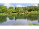 Calm pond reflecting trees and sky, showcasing a peaceful, natural setting at 4649 Dahlia Dr, Pine Lake, GA 30072