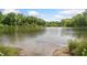 Scenic view of a serene pond reflecting the lush green trees under a partly cloudy sky at 4649 Dahlia Dr, Pine Lake, GA 30072
