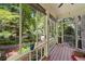 Relaxing screened porch with wood floors and views of the lush backyard and trees at 4649 Dahlia Dr, Pine Lake, GA 30072