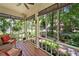 Inviting screened porch with comfortable seating overlooking a serene, wooded landscape at 4649 Dahlia Dr, Pine Lake, GA 30072