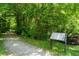 Picturesque walking path surrounded by trees, adjacent to an informational kiosk at 4649 Dahlia Dr, Pine Lake, GA 30072