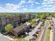 Aerial view of a bustling street with brick buildings and shops near train tracks in the community at 7059 Hunters Rdg, Woodstock, GA 30189