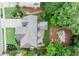 Aerial view of well-maintained home and landscaped backyard, featuring a firepit, mature trees, and manicured lawn at 7059 Hunters Rdg, Woodstock, GA 30189