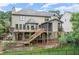 This backyard features a large deck, screened in porch, and lush landscaping at 7059 Hunters Rdg, Woodstock, GA 30189
