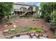 Landscaped backyard with terraced levels, stone retaining walls, a fire pit, and multi-level decks at 7059 Hunters Rdg, Woodstock, GA 30189