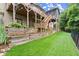 Well-maintained backyard with tiered landscaping, a lush lawn, fencing, and a multi-story deck at 7059 Hunters Rdg, Woodstock, GA 30189