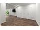 Finished basement with laminate flooring, large closet, TV, and access to the backyard at 7059 Hunters Rdg, Woodstock, GA 30189
