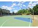Outdoor community basketball court with blue and green painted surface and surrounding greenery at 7059 Hunters Rdg, Woodstock, GA 30189