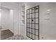 Bathroom featuring a shower with black grid, built-in shelves, and neutral tile at 7059 Hunters Rdg, Woodstock, GA 30189