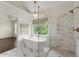 Beautiful bathroom featuring a soaking tub, glass shower, and marble flooring at 7059 Hunters Rdg, Woodstock, GA 30189