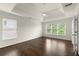 Bright bedroom with hardwood floors, a ceiling fan, and large windows providing ample natural light at 7059 Hunters Rdg, Woodstock, GA 30189