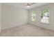 Bedroom with carpet and two windows letting in natural light at 7059 Hunters Rdg, Woodstock, GA 30189
