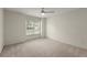 Empty bedroom with neutral carpet and a window overlooking the front yard at 7059 Hunters Rdg, Woodstock, GA 30189