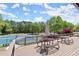 Community deck overlooking tennis courts with outdoor seating and beautiful green landscaping at 7059 Hunters Rdg, Woodstock, GA 30189