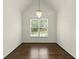 Dining room with hardwood floors and a decorative chandelier under a vaulted ceiling at 7059 Hunters Rdg, Woodstock, GA 30189