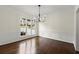 Elegant dining room features a modern chandelier, wainscoting, and large windows at 7059 Hunters Rdg, Woodstock, GA 30189