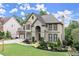 Charming two-story home with stone accents, arched entrance and well maintained landscaping at 7059 Hunters Rdg, Woodstock, GA 30189