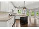 Bright kitchen with white cabinets, granite counters, and an island for food prep at 7059 Hunters Rdg, Woodstock, GA 30189