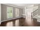 Spacious living room with hardwood floors, plantation shutters, and views into an adjacent room at 7059 Hunters Rdg, Woodstock, GA 30189