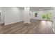 Open living room with laminate flooring, French doors, bright natural light, and neutral decor at 7059 Hunters Rdg, Woodstock, GA 30189