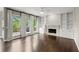 Spacious living room with a fireplace and built-in shelving and large windows at 7059 Hunters Rdg, Woodstock, GA 30189