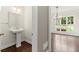Charming powder room with pedestal sink and decorative mirror near the dining area at 7059 Hunters Rdg, Woodstock, GA 30189