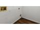 Utility room with wood look floors, white walls, and access to utilities at 7059 Hunters Rdg, Woodstock, GA 30189