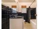 Bathroom with black tiled walls, patterned flooring, and modern vanity at 894 Nottingham Dr, Avondale Estates, GA 30002