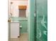 Charming bathroom featuring turquoise tiles, a classic sink, and unique fish-themed shower door at 894 Nottingham Dr, Avondale Estates, GA 30002