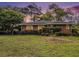 Charming brick home with well-maintained lawn, mature landscaping, and a covered parking area at 894 Nottingham Dr, Avondale Estates, GA 30002