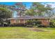 Charming single-story brick home featuring a well-manicured lawn and mature trees in a serene setting at 894 Nottingham Dr, Avondale Estates, GA 30002