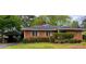 Brick home with a carport and manicured landscaping at 894 Nottingham Dr, Avondale Estates, GA 30002