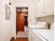 Functional laundry room with washer, dryer, and storage cabinets at 894 Nottingham Dr, Avondale Estates, GA 30002