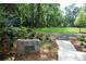 Avondale Estates Park entrance with greenery, a stone marker, and a glimpse of the open field at 894 Nottingham Dr, Avondale Estates, GA 30002