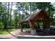 Park pavilion with picnic tables, American flags, and trees surrounding the area at 894 Nottingham Dr, Avondale Estates, GA 30002