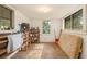 Spacious, unfinished room with natural light, ideal for storage or renovation with wooden shelving and floor at 894 Nottingham Dr, Avondale Estates, GA 30002