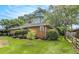 Inviting single-story home with lush green lawn, mature trees, and charming landscape at 894 Nottingham Dr, Avondale Estates, GA 30002