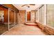 Enclosed sunroom with brick walls, tile floor, and multiple windows at 894 Nottingham Dr, Avondale Estates, GA 30002