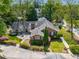 An aerial view of a brick home with a fenced backyard, mature trees, and a detached garage at 1041 Standard Ne Dr, Brookhaven, GA 30319