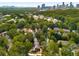 An aerial view showcasing the neighborhood's lush greenery and the city skyline in the background at 1041 Standard Ne Dr, Brookhaven, GA 30319