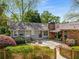 Charming home featuring a spacious backyard patio, lovely landscaping, and inviting outdoor seating area at 1041 Standard Ne Dr, Brookhaven, GA 30319