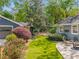Backyard with an artificial lawn, stone patio and lush landscaping at 1041 Standard Ne Dr, Brookhaven, GA 30319