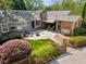 Aerial view of a home showcasing a stone patio, artificial lawn and mature landscaping at 1041 Standard Ne Dr, Brookhaven, GA 30319