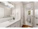 Classic bathroom with a marble countertop vanity, framed mirror, and tiled floors at 1041 Standard Ne Dr, Brookhaven, GA 30319