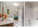 Classic bathroom featuring marble top vanity, black and white tiled floors, and shower at 1041 Standard Ne Dr, Brookhaven, GA 30319