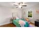 Cozy bedroom with decorative pillows, hardwood floors, and a sunny window at 1041 Standard Ne Dr, Brookhaven, GA 30319