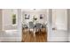 Bright dining room with hardwood floors, modern lighting, and an open view to the living spaces at 1041 Standard Ne Dr, Brookhaven, GA 30319