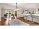Bright kitchen features white cabinetry, marble countertops, stainless appliances, hardwood floors, and bar seating at 1041 Standard Ne Dr, Brookhaven, GA 30319